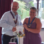 President Robyn receiving a Pennent from DG Chris