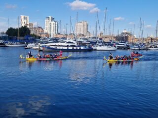 Two Dragon Boats racing in a heat Two Dragon Boats racing in a heat